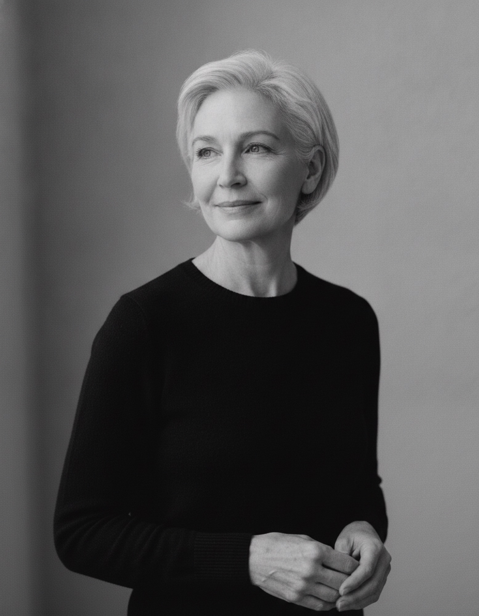 Black and white portrait of Elena Marsh in a dark sweater, smiling softly